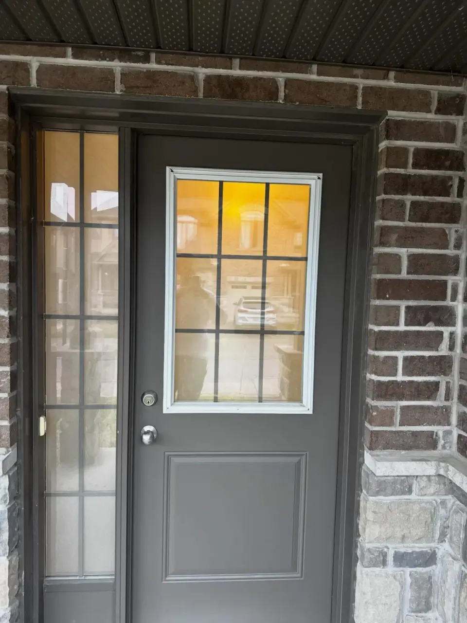 Exterior front door and trim on a brick home